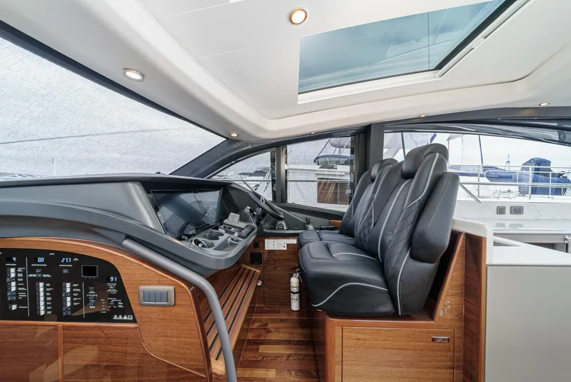 Slide: The Image of Interior of 2025 Princess V55 yacht, featuring sleek dashboard and luxurious seating. - 31