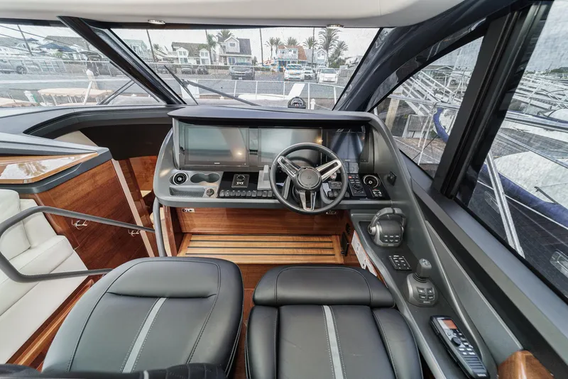 Slide: The Image of 2025 Princess V55 yacht cockpit with modern controls and leather seating. - 32