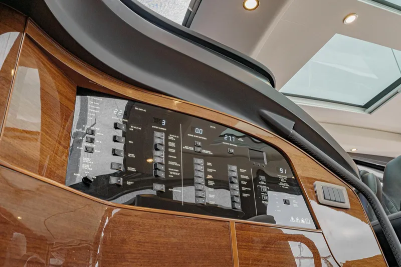 Slide: The Image of 2025 Princess V55 yacht dashboard with sleek wood paneling and modern controls. - 34