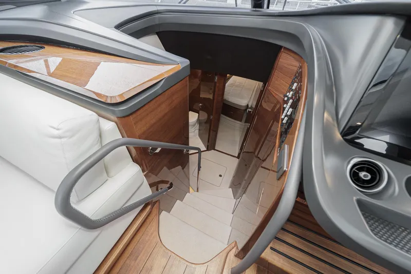 Slide: The Image of Interior view of 2025 Princess V55 yacht, featuring sleek wood finishes and modern design. - 35