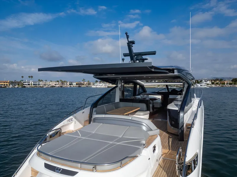 Slide: The Image of Luxury 2025 Princess V55 yacht on calm waters, featuring sleek design and spacious deck. - 4
