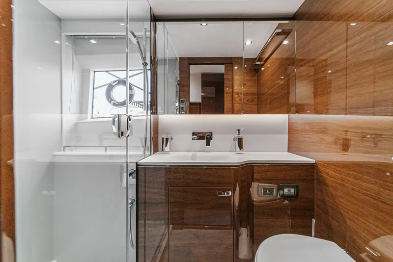Slide: The Image of Luxurious bathroom in 2025 Princess V55 yacht with modern fixtures and wood accents. - 40