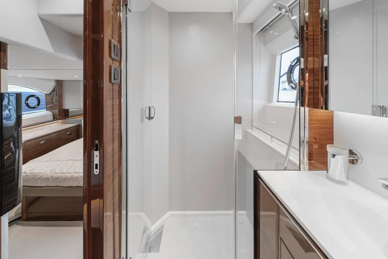 Slide: The Image of Luxurious interior of 2025 Princess V55 yacht, featuring modern bathroom and bedroom. - 41