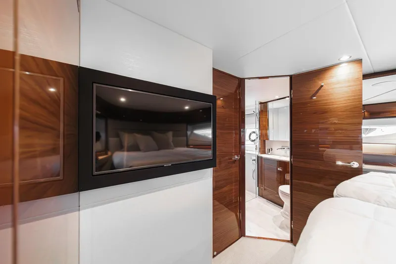 Slide: The Image of Luxurious interior of 2025 Princess V55 yacht with modern TV and elegant wood finishes. - 44