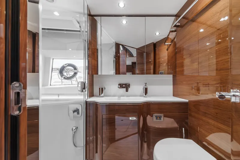 Slide: The Image of Luxurious bathroom in 2025 Princess V55 yacht with sleek wood paneling and modern fixtures. - 46