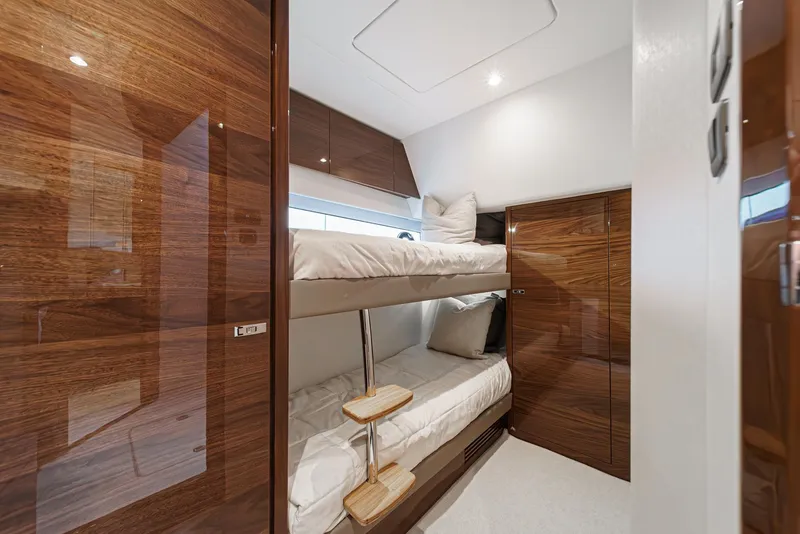 Slide: The Image of Luxurious 2025 Princess V55 yacht cabin with wooden bunk beds and modern design. - 48