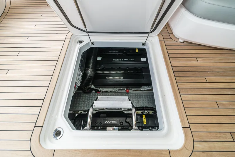 Slide: The Image of Engine compartment of 2025 Princess V55 yacht with open hatch on teak deck. - 49