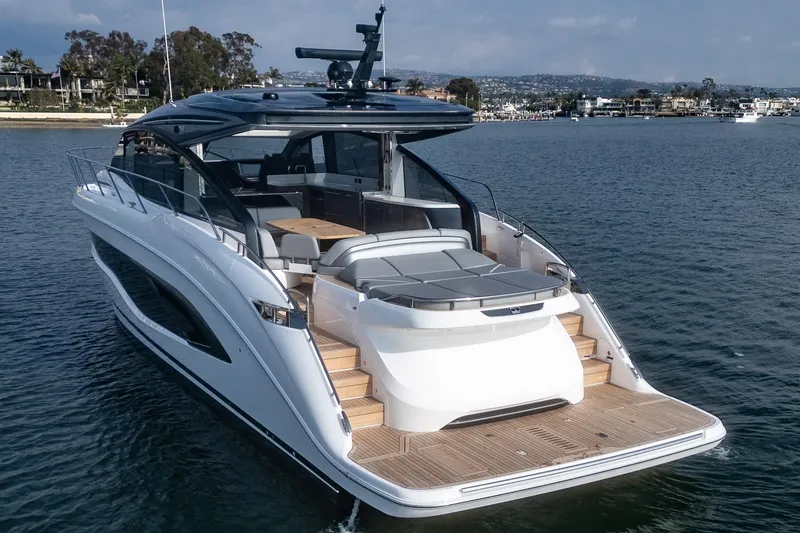 Slide: The Image of 2025 Princess V55 luxury yacht on calm water, showcasing sleek design and spacious deck. - 5
