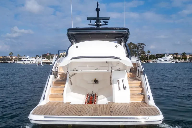 Slide: The Image of 2025 Princess V55 yacht rear view on water, showcasing elegant design and spacious deck. - 6