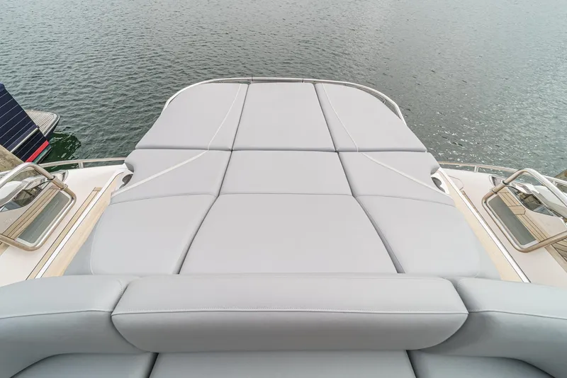 Slide: The Image of 2025 Princess V55 yacht sunbed overlooking calm water. - 7