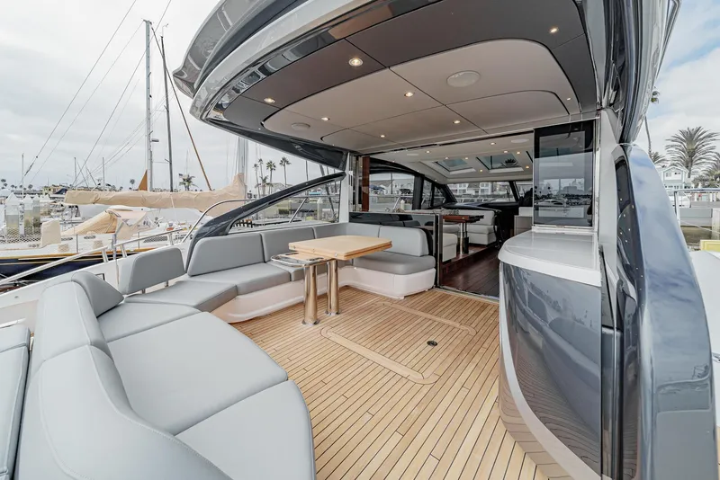Slide: The Image of Luxurious 2025 Princess V55 yacht with spacious deck and modern seating area. - 8