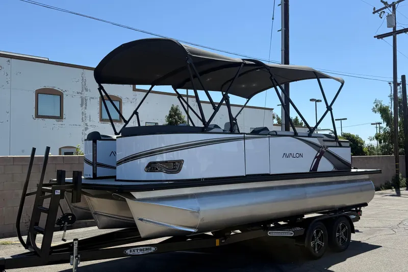 The Image of 2025 Avalon 2185 LSZ QL pontoon boat on trailer, parked outdoors. - 0