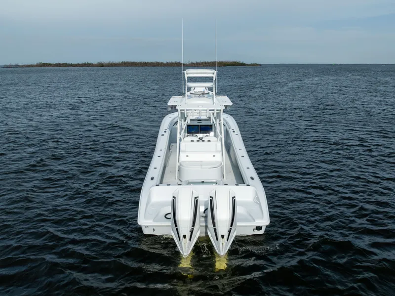 Slide: The Image of 2021 Yellowfin 36 Offshore boat on open water, rear view. - 1