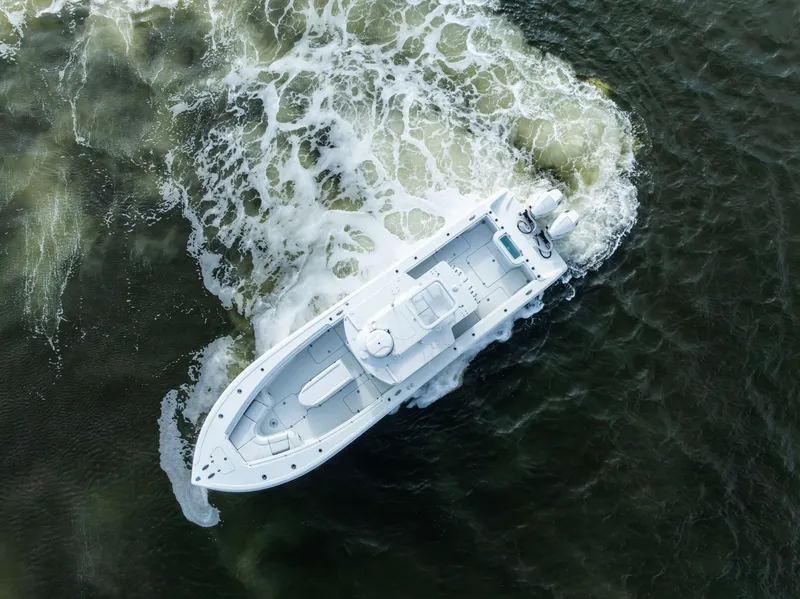 Slide: The Image of Aerial view of 2021 Yellowfin 36 Offshore boat navigating through water. - 17
