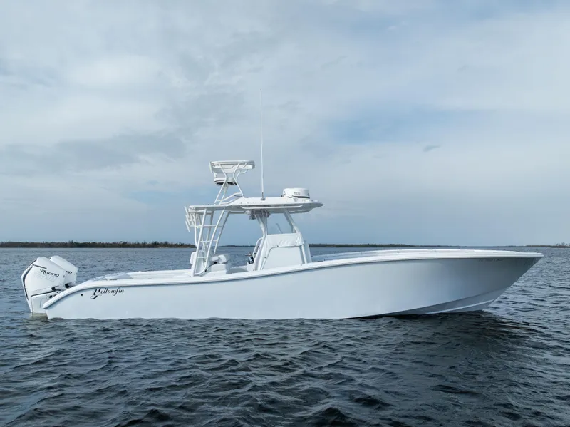 Slide: The Image of 2021 Yellowfin 36 Offshore boat on calm water under cloudy sky. - 2