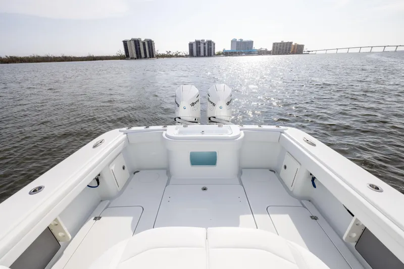 Slide: The Image of 2021 Yellowfin 36 Offshore boat on water, city skyline in background. - 20