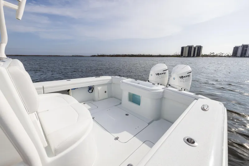 Slide: The Image of 2021 Yellowfin 36 Offshore boat on calm water with twin engines. - 21