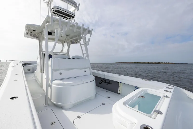 Slide: The Image of 2021 Yellowfin 36 Offshore boat on open water, showcasing spacious deck and seating. - 28