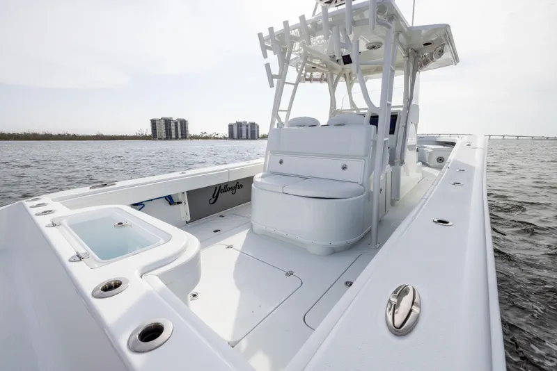 Slide: The Image of 2021 Yellowfin 36 Offshore boat on water, featuring spacious deck and seating. - 30