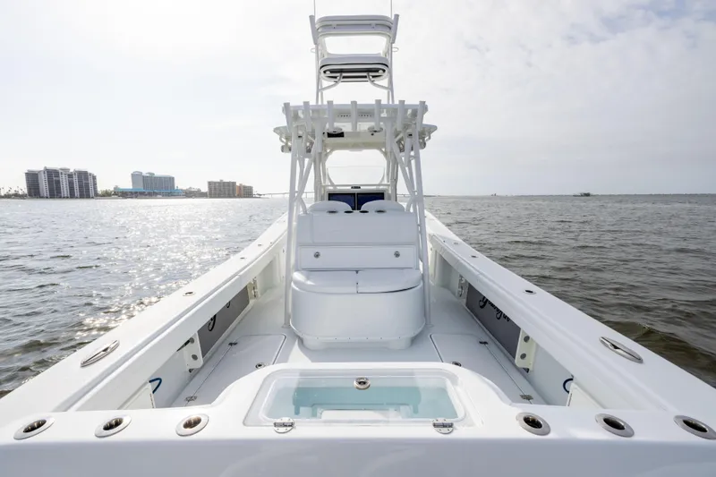 Slide: The Image of 2021 Yellowfin 36 Offshore boat on open water, clear sky, city skyline in background. - 31