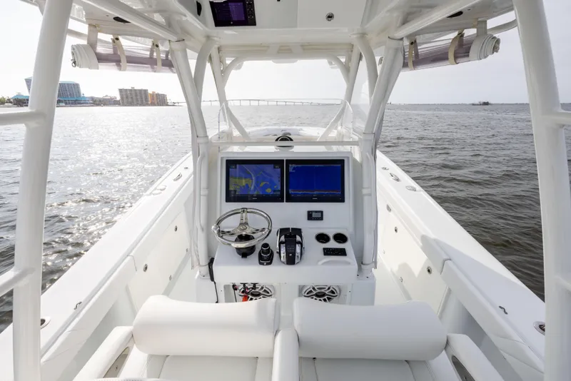 Slide: The Image of 2021 Yellowfin 36 Offshore boat cockpit with dual navigation screens on open water. - 36