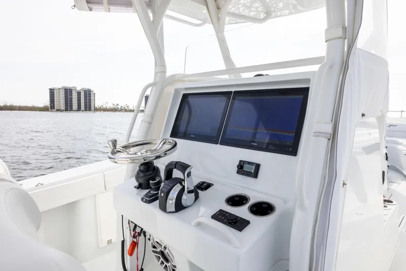 Slide: The Image of 2021 Yellowfin 36 Offshore boat console with dual screens and steering wheel. - 38