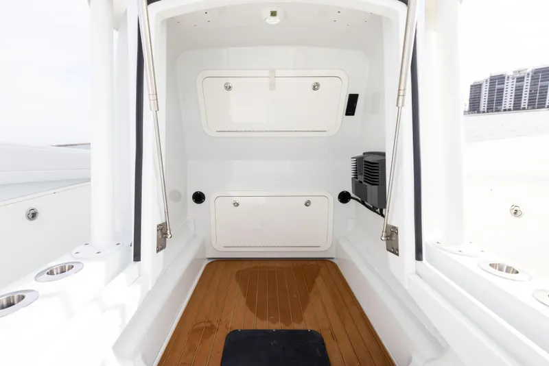 Slide: The Image of 2021 Yellowfin 36 Offshore boat interior with wood flooring and storage compartments. - 46
