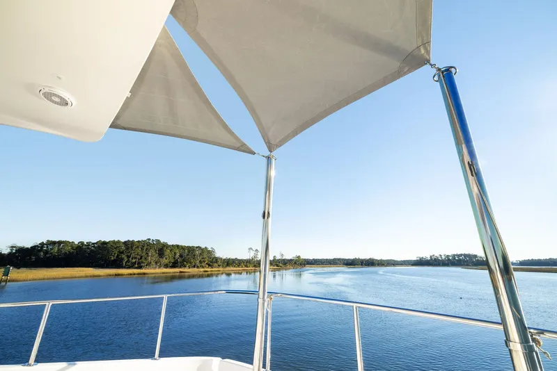 Slide: The Image of Luxurious interior of 2016 Hatteras M60 yacht with plush seating and scenic water view. - 12