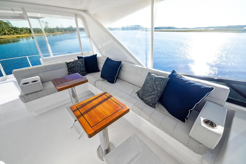 Slide: The Image of 2016 Hatteras M60 yacht helm with modern navigation system on serene waterway. - 14