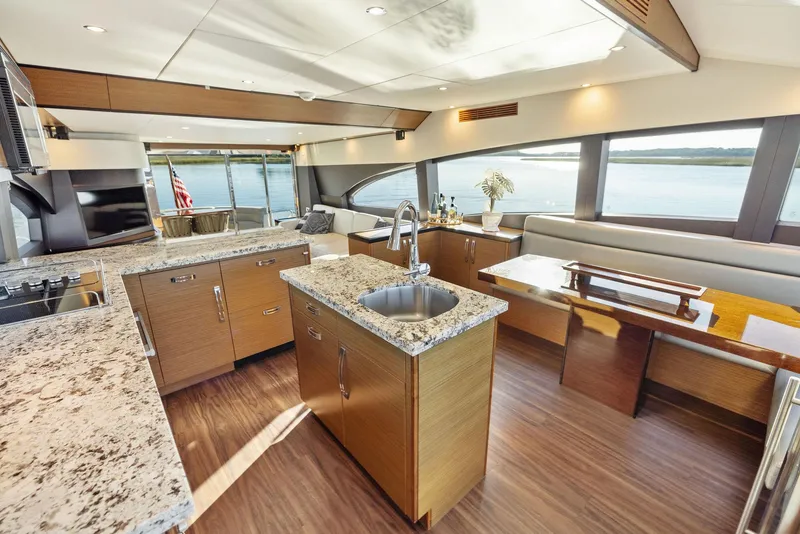 Slide: The Image of Luxurious interior of 2016 Hatteras M60 yacht with elegant wood table and plush seating. - 20