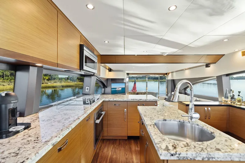 Slide: The Image of Luxurious kitchen interior of 2016 Hatteras M60 yacht with modern appliances and scenic view. - 23