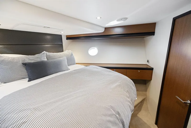 Slide: The Image of Luxurious bedroom interior of 2016 Hatteras M60 yacht with modern design and cozy bedding. - 28