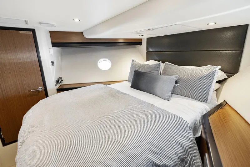 Slide: The Image of Luxurious 2016 Hatteras M60 yacht bedroom with TV and modern decor. - 29