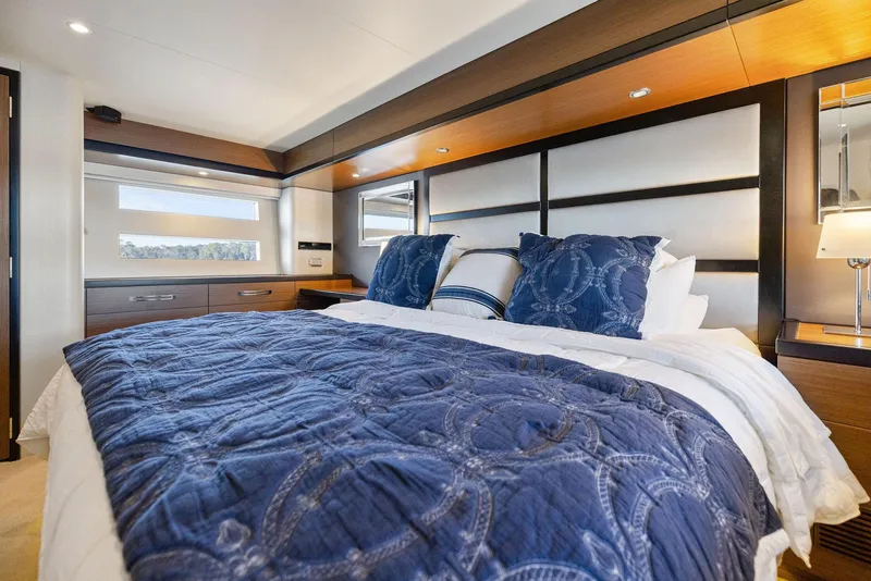 Slide: The Image of Luxurious bedroom interior of 2016 Hatteras M60 yacht with blue bedding and modern decor. - 38