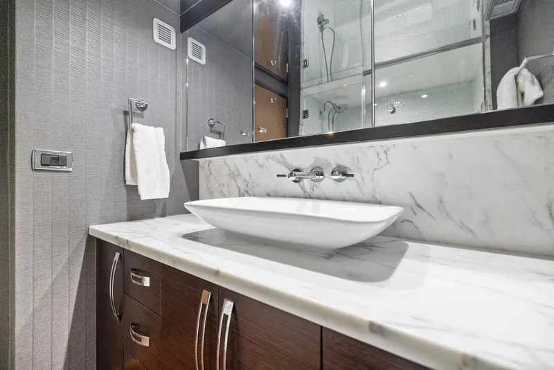 Slide: The Image of Luxurious shower in 2016 Hatteras M60 yacht with marble tiles and modern fixtures. - 41