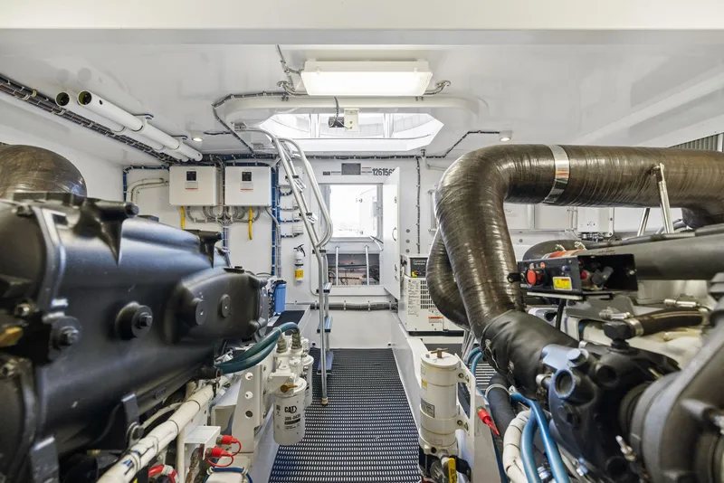 Slide: The Image of Engine room of 2016 Hatteras M60 yacht, showcasing complex machinery and wiring. - 44