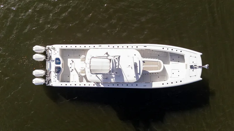 Slide: The Image of Aerial view of 2023 Freeman 42LR boat with triple engines on water. - 36