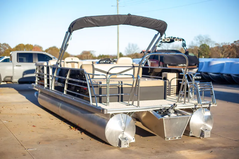 The Image of 2025 Trifecta 24UL CS pontoon boat with canopy on a sunny day. - 1