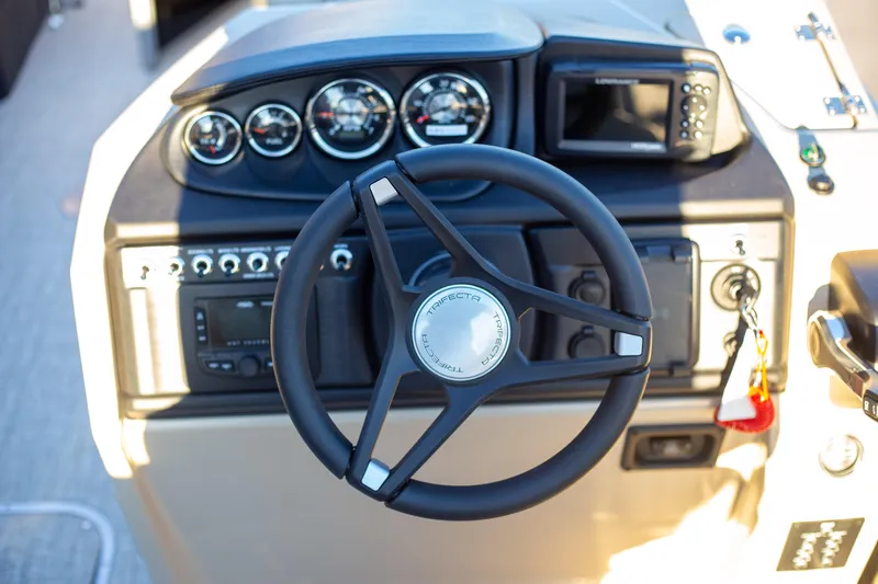 Slide: The Image of Steering console of 2025 Trifecta 24UL CS boat with gauges and controls. - 13