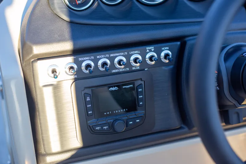 Slide: The Image of Control panel of 2025 Trifecta 24UL CS boat with switches and audio system. - 15