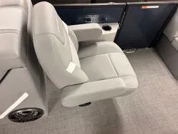 Slide: The Image of 2024 Crest Classic DLX 200 interior with gray seating and cup holders. - 11