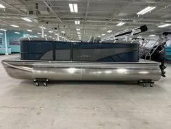 Slide: The Image of 2024 Crest Classic DLX 200 pontoon boat in showroom, side view. - 3