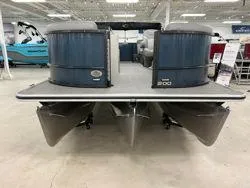 Slide: The Image of 2024 Crest Classic DLX 200 pontoon boat in showroom, rear view. - 6