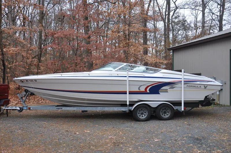 Slide: The Image of 2006 Formula 271 FASTech boat on trailer, parked outdoors in autumn setting. - 1