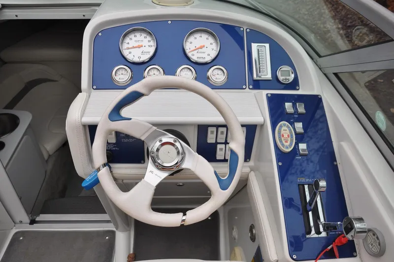 Slide: The Image of 2006 Formula 271 FASTech boat dashboard with steering wheel and gauges. - 10
