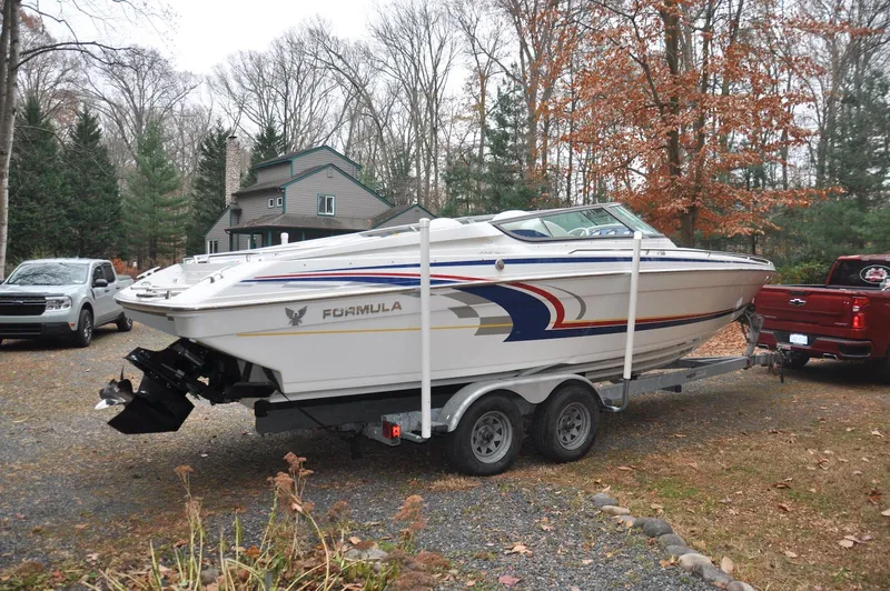 Slide: The Image of 2006 Formula 271 FASTech boat on trailer in wooded driveway setting. - 3