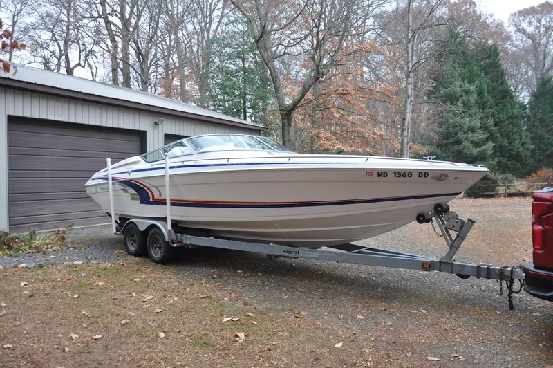 Slide: The Image of 2006 Formula 271 FASTech boat on trailer near garage, surrounded by trees. - 4