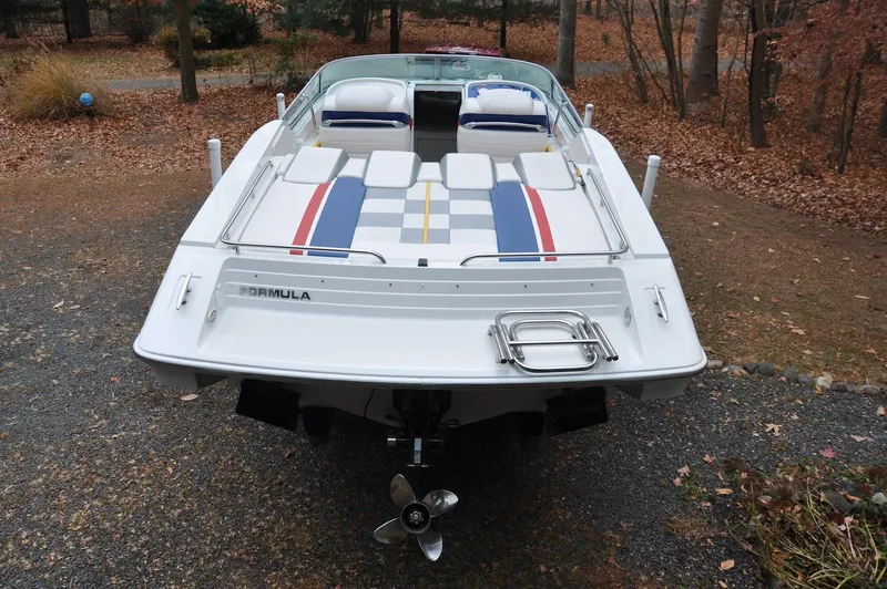 Slide: The Image of 2006 Formula 271 FASTech boat, rear view, parked on gravel, surrounded by autumn leaves. - 6