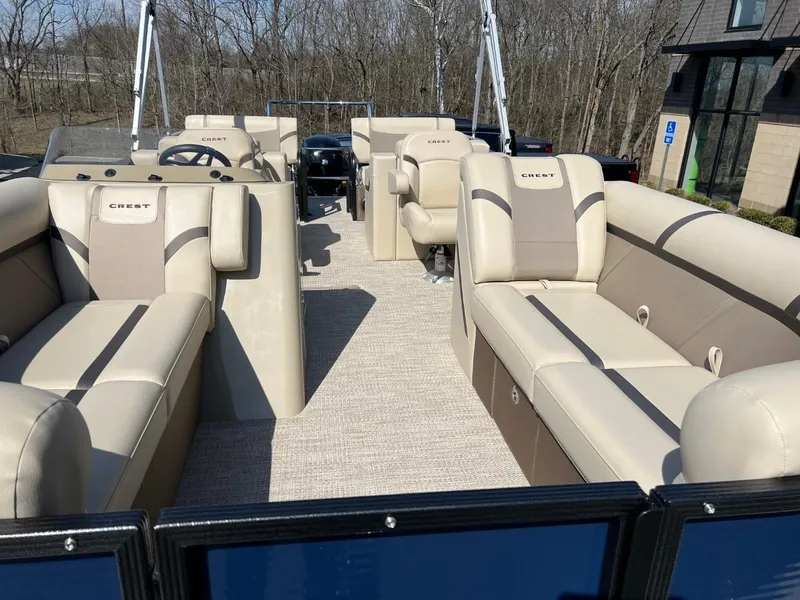 Slide: The Image of 2024 Crest Classic LX 220 pontoon boat with spacious seating and modern design. - 5