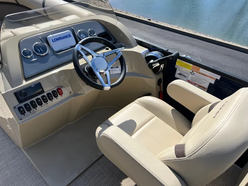 Slide: The Image of 2024 Crest Classic LX 220 boat helm with steering wheel and control panel. - 7